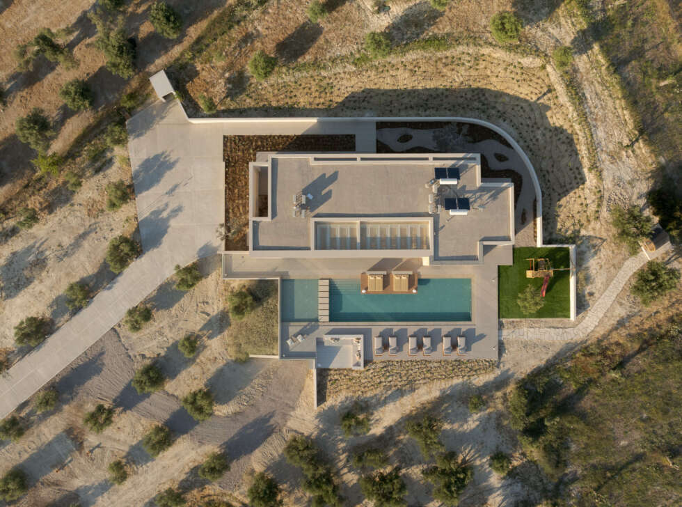 Bird's eye view from the villa grounds, featuring a play area, outdoor sauna, and signature pool area.