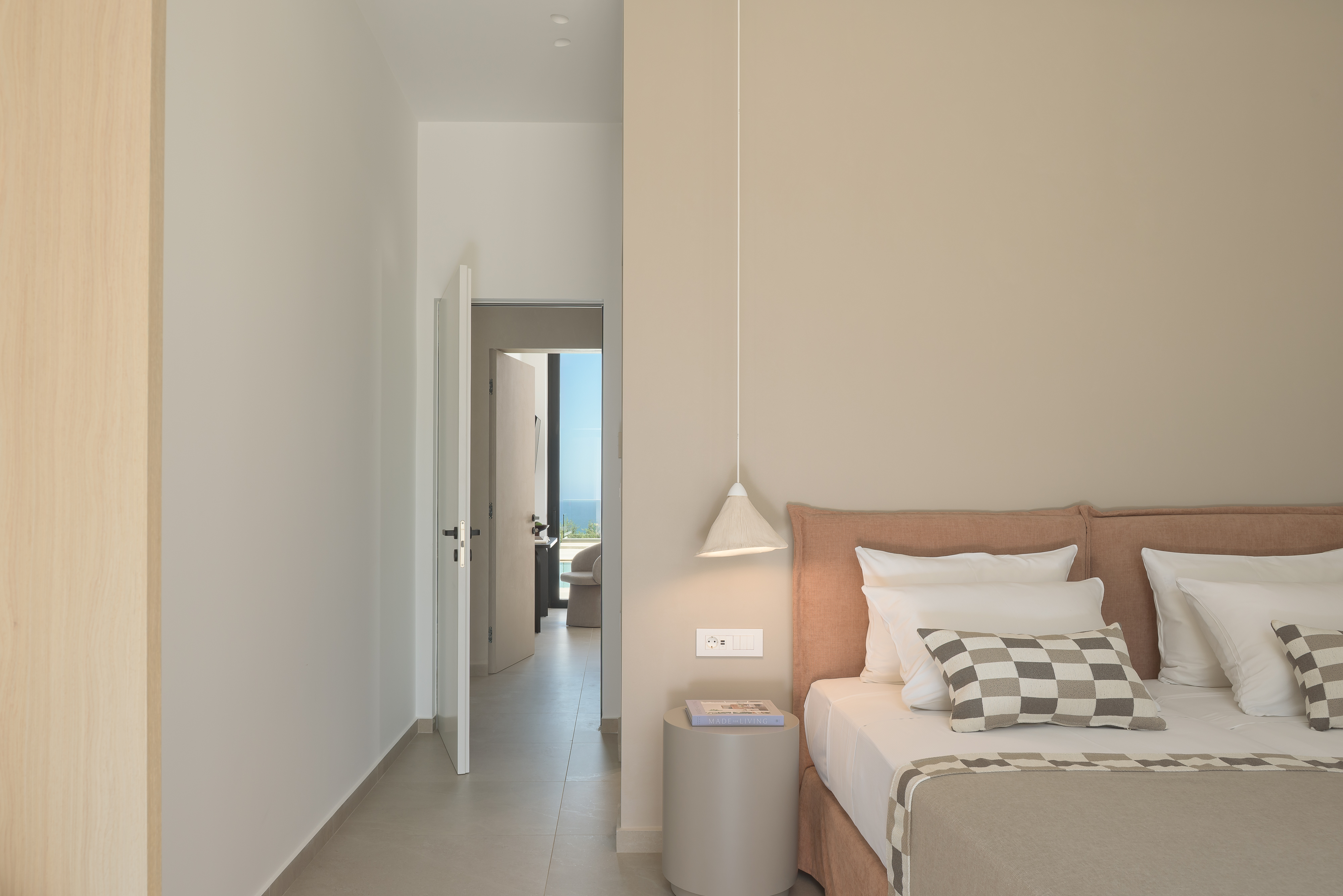 This en-suite Twin bedroom invites restful nights and quiet mornings, wrapped in soft fabrics and earthy island tones.
